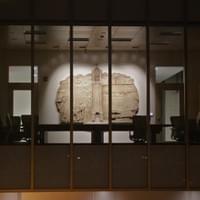 Night view of lit sculpture from front steps