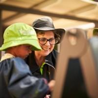 Educator painting with a child outdoors