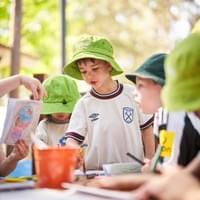 Children drawing together outdoors