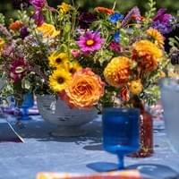 Spring inspired low centerpiece featuring bright colored wild flowers