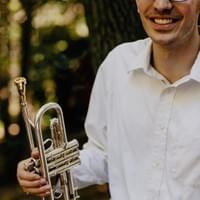 partial headshot with a trumpet