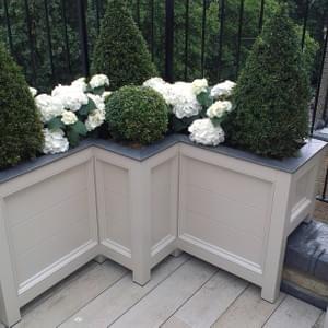 Flat top parterre corner with horizontal planking, tailored  to accommodate balcony wall to maximise usable floor area