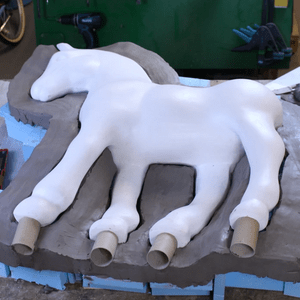 A clay dam was built to the desired seam line, splitting the piece into two halves. 