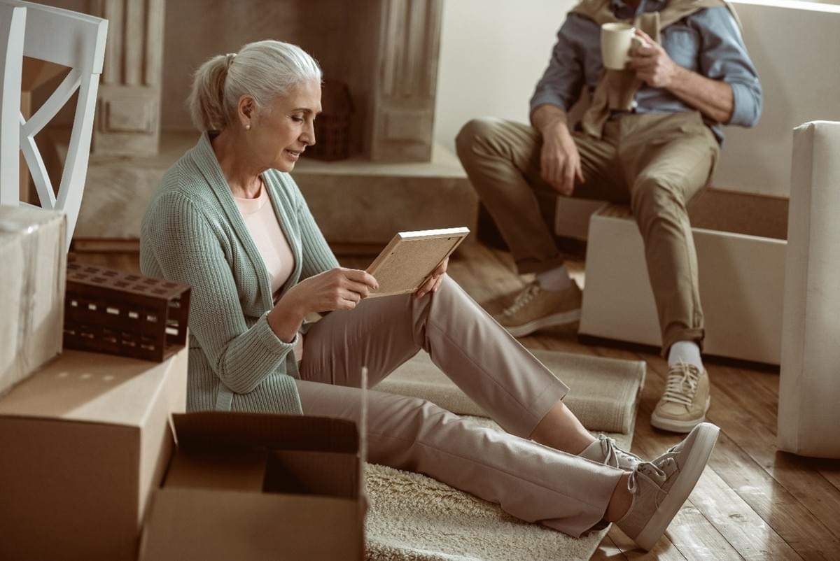 Woman reviewing family belongings while downsizing