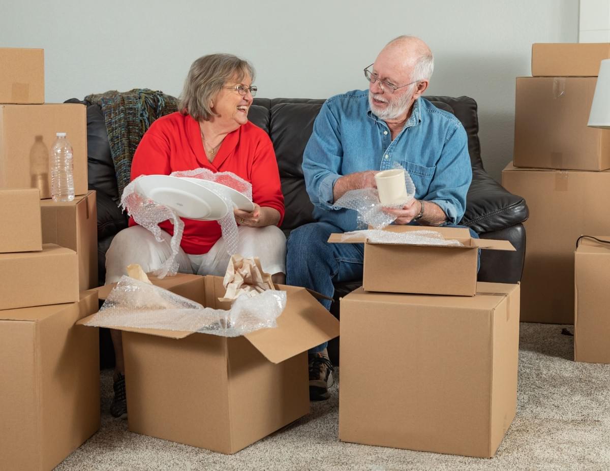 Senior couple packing household items