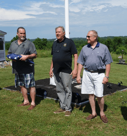 Mount America 2019 Honoree, Gold Star father Charlie Strange, receiving the flag signed by all veterans.  Pictured with him are George Turak, Purple Heart recipient and Admiral Joseph Hare.