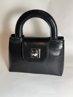 Black Italian leather mini top handle bag with structured silhouette and silver metal clasp, elegant minimalist luxury handbag, Made in Italy craftsmanship, wholesale leather accessories