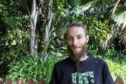 "I burned everything I had in Germany. I burned everything like all the furniture and all the stuff that I owned on a big pile and then I just grab my backpack with my kilograms and went to Australia. I just brought myself up here in Nimbin and I just stayed. I was invited to a community where I was living for nearly one and half years; it’s a self-sustainable community. So, we’re just using rainwater and we’re growing our own veggies and we have couple of chickens to get some eggs, and stuff like that. We’re trying to be self-sufficient completely. And my story is like; I want to step out of the society really. Don’t want to be part of that, like normal. Because for me, it makes no sense, for me, I have to come back to nature. I have to find myself. I have to sort out my problems and I have to go my own little pathway. For me, the normal society is just about rushing and being something and owning something. And like, the more money you have the more you’re accepted in society. So, I am just trying to get out of all that.  I’d like trying to be on myself, to support myself. That’s what I need and I just don’t give a f* about what people think of me or don’t wanna be in a work structure as well. I don’t like to work for the company just to raise their profit. Because I would like to work in a company where everybody is owning the same kind of money, the same amount of money so there is no f*king hierarchy; boss, vice boss and then its like going down and down and down. For me, it should be, everyone, and everybody should earn an equal amount of money when we work for the company together.  Don’t know, its just about that the whole f*king world has been surrounded the capital. I’m not a big fan of that. Especially, because we are producing all the problems of the world, like all the countries that are really well with money like Germany for example in Europe or France, is not too bad as well. But on the other side, you have all that countries where people are really like suffering and you got so many refugees now, like all over the world. And its just like the people are not thinking, okay, let’s do something together to figure out the problem. The people are just like, separating again. They’d like; there’s we and there’s the others. So, I really don’t like that. Because for me, the label ‘refugee’; just the label ‘refugee’ for human being. It’s just wrong because it’s a human like you and me. Its like not a like, I am a refugee; you can say that as well. Like, I was escaping from Germany you know. But only by putting that label on persons you make them different. That’s why people are scared of it because it is a different thing. And it is like not part of me, it’s part of something else. That’s the problem. I think people have to get over that.  I was struggling the most really when I was living in Germany and I just didn’t feel accepted. In my way of thinking, I just felt pushed out and I mean, there are lots of hard moments actually in my life. My mom got cancer for example and I had lot of troubles with the police. They broke my nose, they broke my chin, and they broke my ribs just because I stand up for my right and were just saying my opinion on protests and stuff like that.  We had a little house where all the alternative people were living. It was unoccupied house. It’s like an empty house that we just used for cultural center to give the people the chance and the opportunity to come to our place to be out of that moral structure. And then one night, police just came in and they smashed the whole building. They just beat everybody up who was in that building. We couldn’t do anything. We were like sitting on the ground, with our hands up but the police just didn’t give f*. They just came in and pepper sprayed and directly beat up everybody with their f* truncheons. And I don’t know. It’s just like, you know when you’re trying to be, you tried to do your own thing and you’re not harming anybody. So you’re not like you’re doing anything, which is disturbing anybody else. But there’re still people trying to push you down.  So yeah, for me, the hardest thing is anyway, to accept how the world is running, really. That is my biggest issue, like why the world as it is. Why the people is f* greedy? And why they’re not supportive? Why they’re not like living in solidarity? Why they are not using the potential that we have to create something beautiful? Create something for everybody happy. But people are always on their own ego thing. So, that’s my think. That’s my thinking. That’s my issues. That’s my kind of stories.I’m kinda of hiding here, really. I mean Nimbin is beautiful and I really like it. But in the end, I’m really like hiding. Because there’s nothing else what I am doing here. Just like being here is time stops and you don’t have to think too much about any problems and you can just like live from day to day. But in the end, that is not the solutions as well. You know, it’s not. Because I wanna make some changes as well. It is not happening by just sitting here and smoking some joints. It is pretty much some kind of retreat as well, to calm yourself down and to get some new energy. To use that energy; to use that energy to get out of that with more power afterwards. So, it’s just like… That’s what I’m saying it’s not a place forever. It’s a place where you can have like your retreat, your leave and everything. You’re taking a leave with your time. When you have the power again, you have to use that power to do something else.  When my mother got cancer, I was pretty much with myself all the time trying to suck it all up and didn’t let it out. I am trying to figure it out with myself. I was not talking to anybody. I was not like the guy who is always around my mom. And then I wasn’t talking to people, talking to her and trying to help her. I was just like mainly on myself, just to figure out what I can do but I couldn’t find a way to help because it was really hard for me. But in the end, I just like I figured out that it was not my fault that I was not there. Because there was an issue for me that I had overthinking; I was not there enough for my mom at that time. Eventually, I thought, nah, that’s just a way for me how to deal with it. I couldn’t be there all the time because that would have destroyed me.  I was just trying my best, trying to figure out with myself how I can handle the situation. In the end, it worked well. She fought the cancer. It was quite nice. But it was just heavy experience. It was just like having Christmas and then my mom having no hair and baldhead, looked really sick. In the end, it made me stronger anyway. I’m just following my way actually.  From that experience, I learned that it is not about guilty. There is nothing you have to feel guilty about. Because it doesn’t matter how you react or how you’d like to do or what you are doing in that whole situation like that. It’s just like; your own personality, which is creating that behavior. So, it is not bad to have that kind of behavior. Even if you feel guilty about something, it doesn’t matter because it’s just you. So it makes you as a person. That’s what I found out really. For me, Nimbin is just a place. I can just shut off all that bloody thinking. I’m thinking so much all the time. And see, I just can like shutting it off. I can put a switch and I am not thinking anything. I can’t do that anywhere else in the world. I could never sleep in Europe; I was not able to sleep. Here, I’m sleeping like a baby.  There is so much about that energy. For me, it’s all about energy. The place, which has energy where I can suck up that energy and use it for my self, for my inner body, then it’s definitely the right place for me. So that’s when I felt Nimbin is right. Because I just felt the energy of the area. There is a lot of healing energy here; the sea, and the wind."