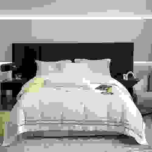 cotton bedding with golden embroidered stripes.