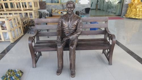Cast bronze life size man and bench statue for outdoors decorated