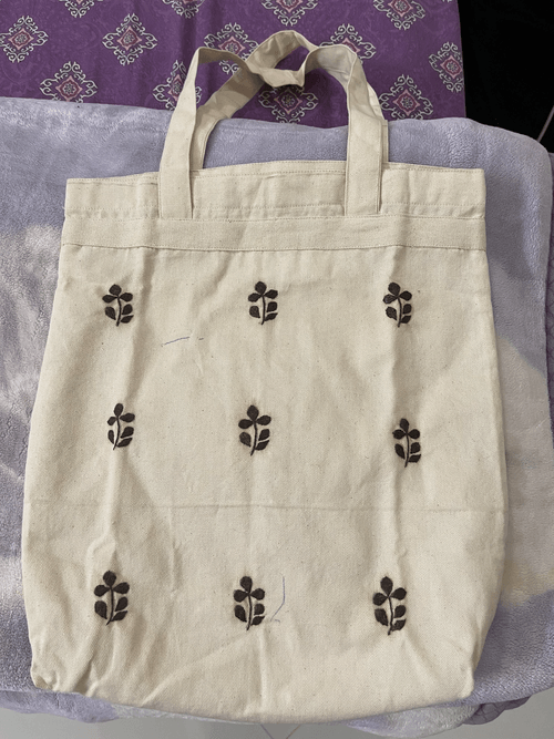 White bag with brown leaves