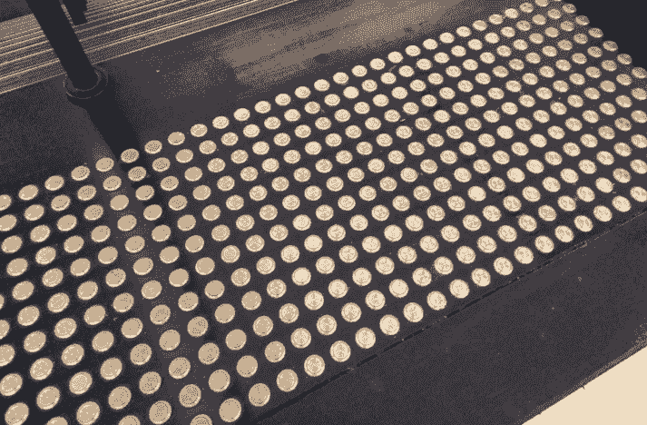 a project team are marking up a set of building plans on a large desk a project team are marking up a set of building plans on a large desk