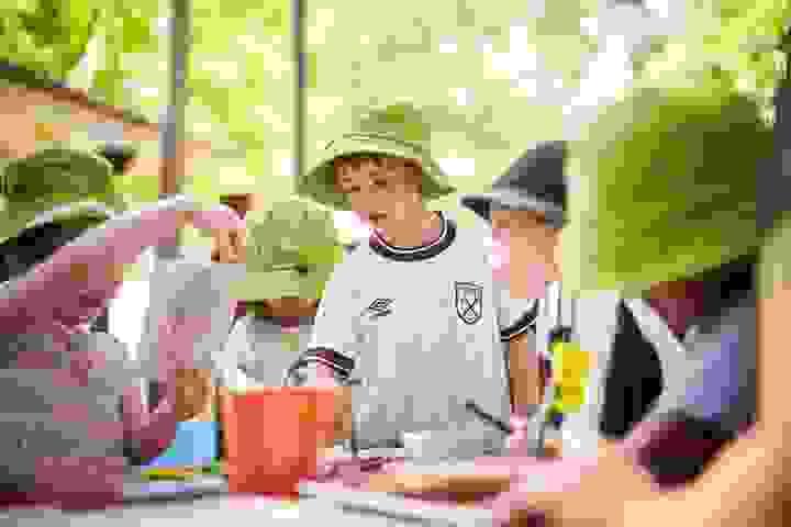 Children drawing together in green Fern Gully hats Children drawing together in green Fern Gully hats