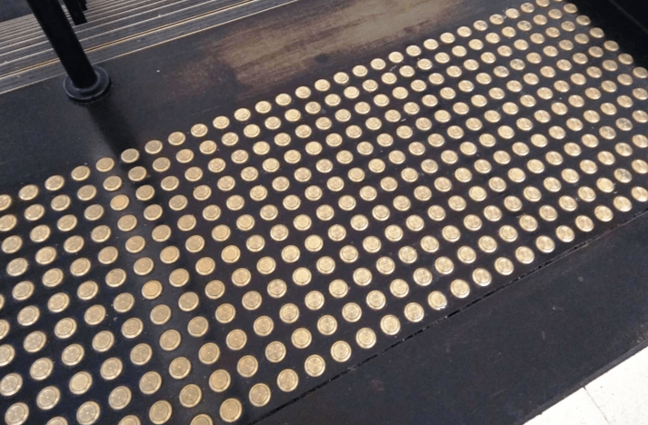 a project team are marking up a set of building plans on a large desk