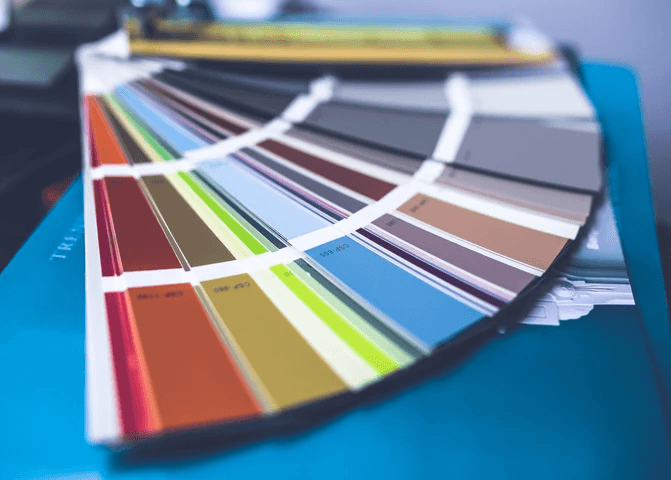 An open fan deck of paint colour samples