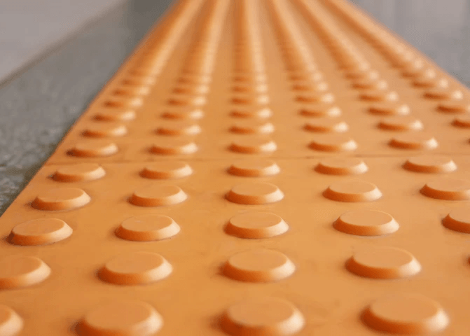 Close up of orange integrated tactile indicators
