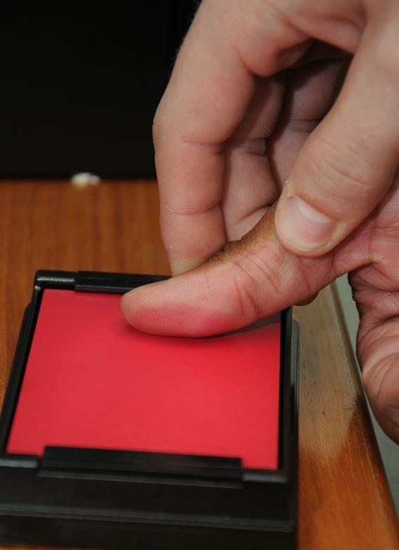 Man being fingerprinted