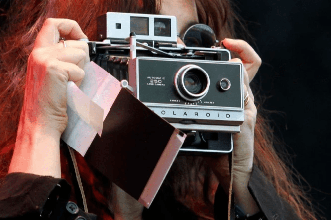 woman with Polaroid camera
