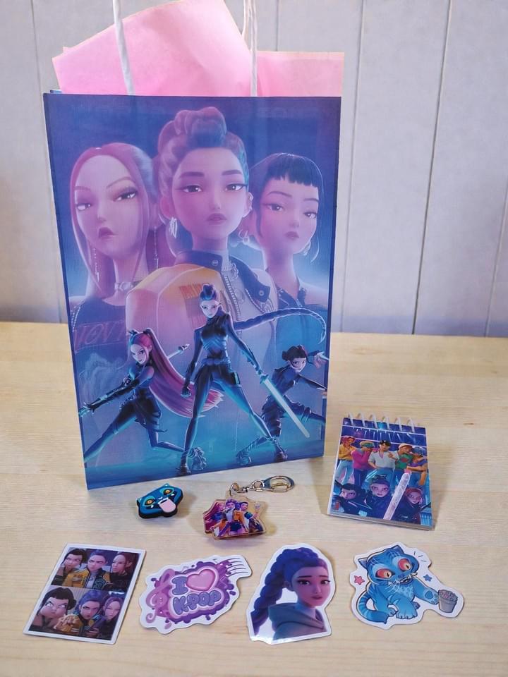 K Pop Demon Hunters themed party bag with keyring shoe charm notebook and stickers