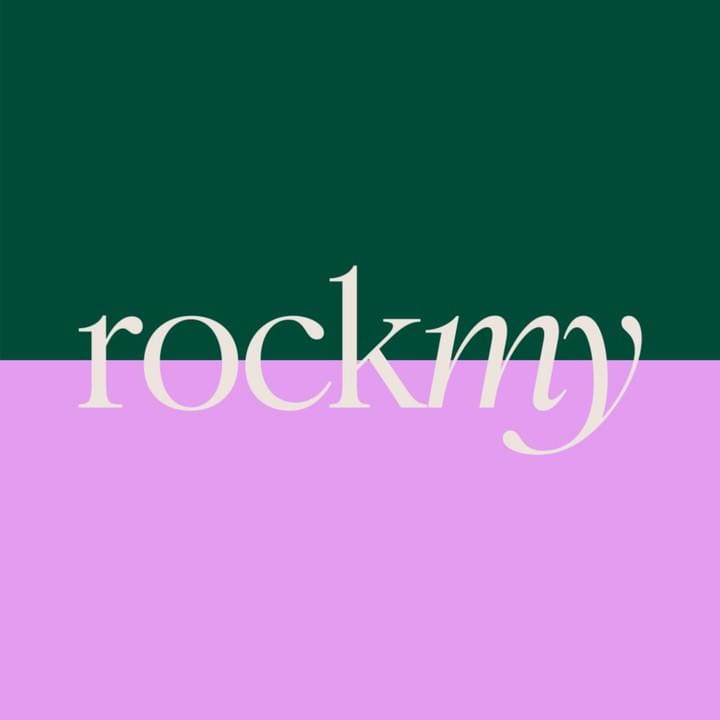 Square shaped logo. Tops half is dark green and the bottom half is lilac. Where the two colours meet, it says ‘rock my’ in white.