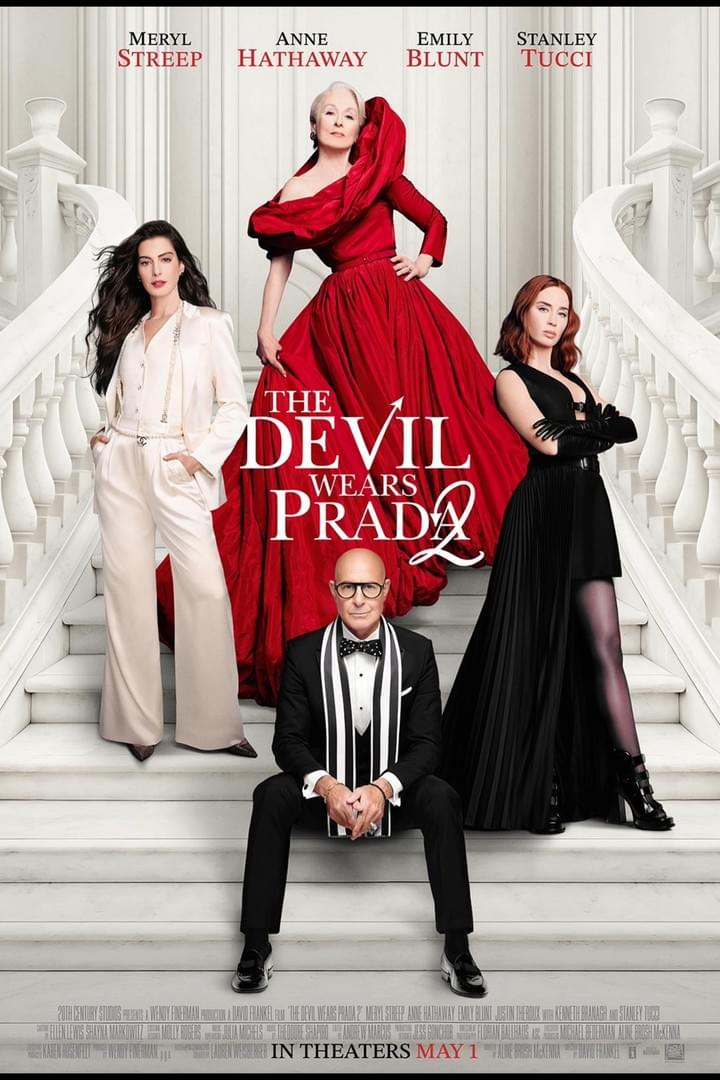 Movie poster featuring four actors posing on a grand white staircase with elegant attire, promoting "The Devil Wears Prada 2." Title is centered in bold red and white text, with actors' names in red at the top and release date "May 1" at the bottom.