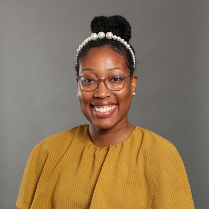 Merci Best in her Michigan postdoc shirt and tam