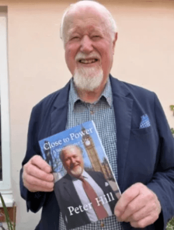 Author Peter Hill holding his book