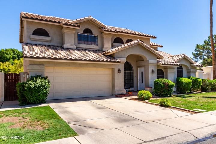 Front exterior of 4-bedroom home for sale in Val Vista Lakes, Gilbert AZ—corner lot with no rear neighbors in gated community.