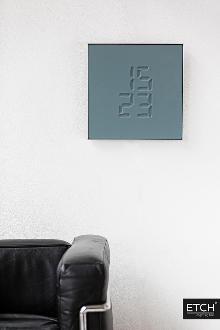 ETCH Clock hanging on wall