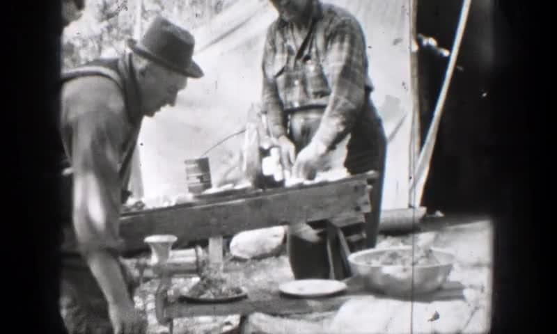 1939: Chelan, Washington. A Couple Of Men Standing Working In A Camp