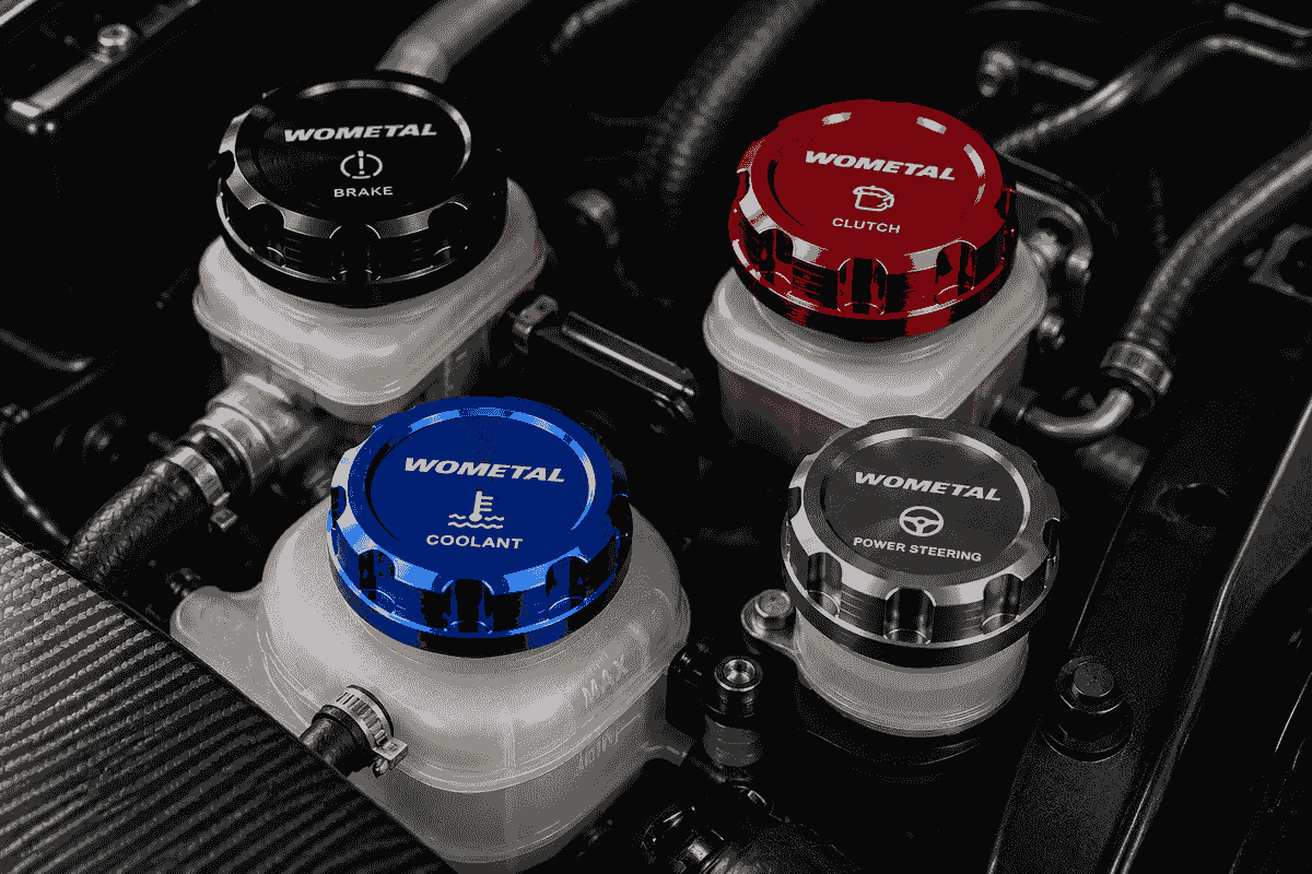 Billet aluminum reservoir caps installed on brake clutch coolant and power steering systems in a high performance vehicle engine bay Billet aluminum reservoir caps installed on brake clutch coolant and power steering systems in a high performance vehicle engine bay