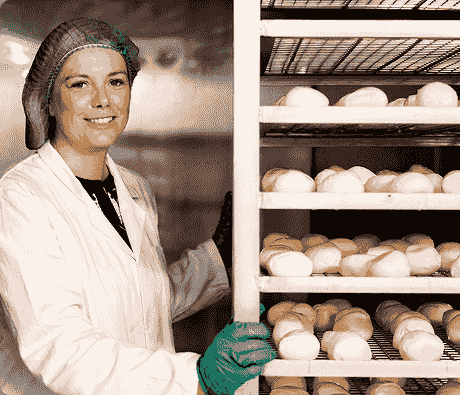 Lonergan family member beside racks of mozzarella during the smoking process. Lonergan family member beside racks of mozzarella during the smoking process.