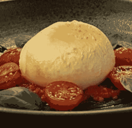 Naturally smoked mozzarella served with tomatoes and basil. Naturally smoked mozzarella served with tomatoes and basil.