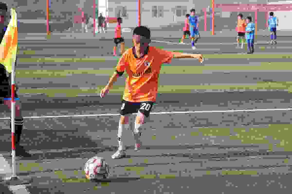 A youth player making a free kick during the talent selection camp