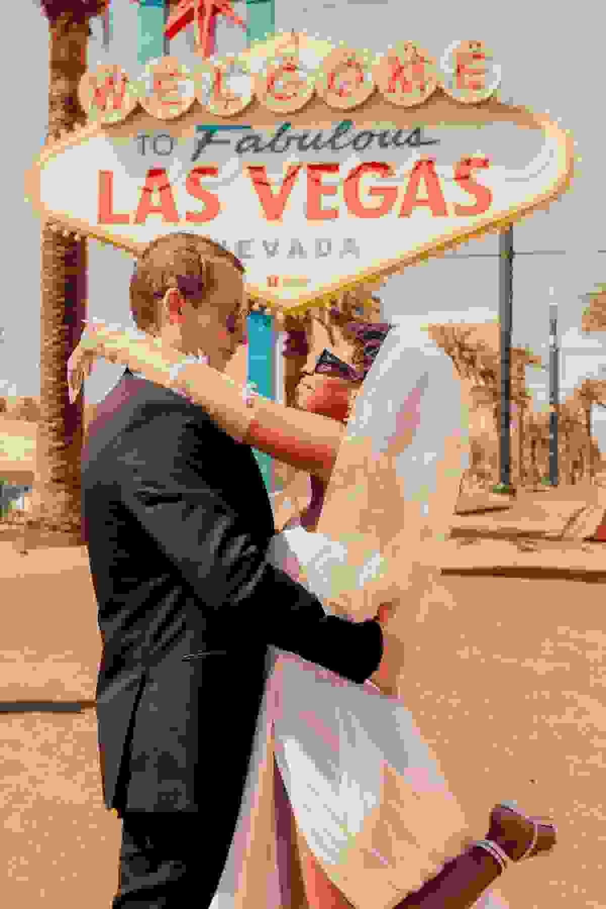 Couple posing together in front of the iconic Welcome to Las Vegas sign at night, capturing vibrant lights and a classic Vegas vibe.