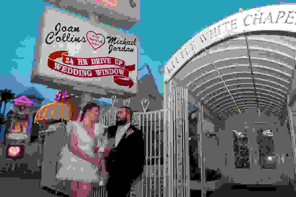 Couple standing outside the Little White Wedding Chapel in Las Vegas, ready for their elopement.