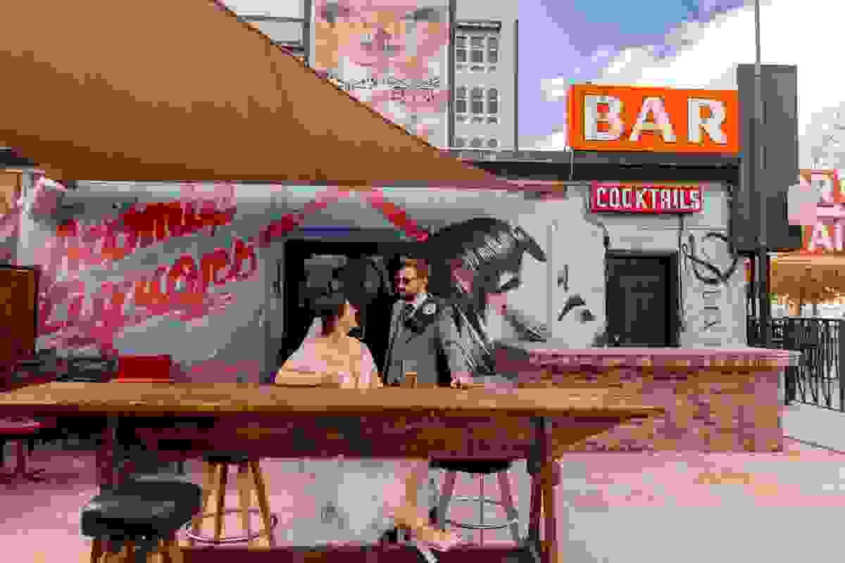 Couple enjoying a photo session outside Atomic Liquors, the iconic Fremont Street bar in Downtown Las Vegas.