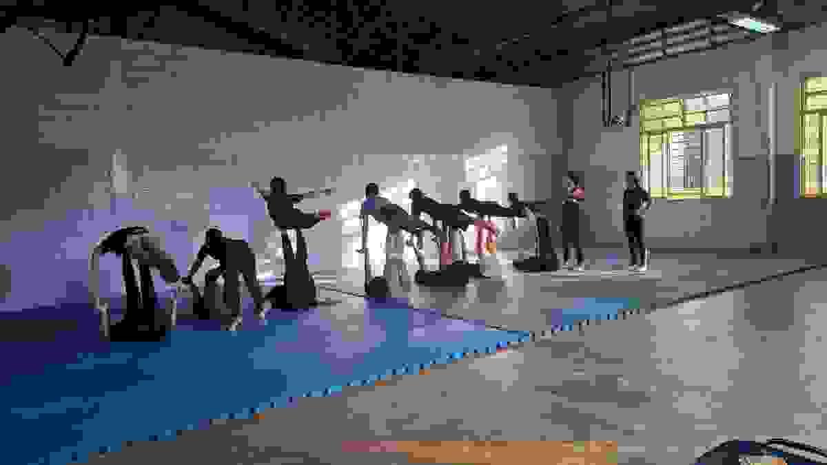 A collection on students learning how to balance on each other feet horizontally A collection on students learning how to balance on each other feet horizontally