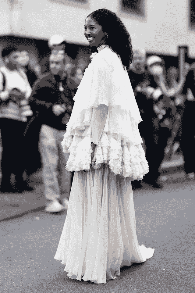 Natalia paired the ensemble with a structured black handbag, black footwear just peeking beneath the gown, and subtle gold jewelry