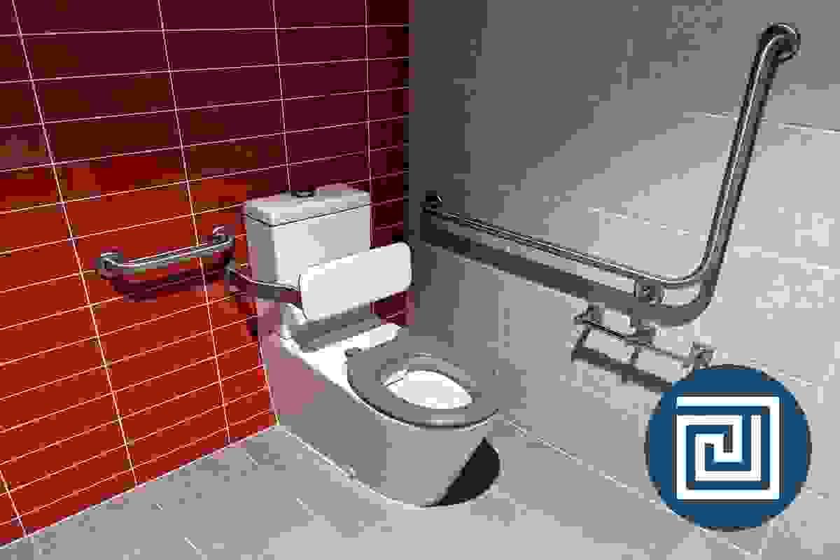 An accessible toilet in a corner of a room with a grey seat and grabrails An accessible toilet in a corner of a room with a grey seat and grabrails