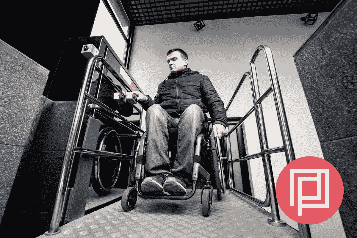 Portrait of a man using a wheelchair smiling next to some columns in a doorway with logo Portrait of a man using a wheelchair smiling next to some columns in a doorway with logo