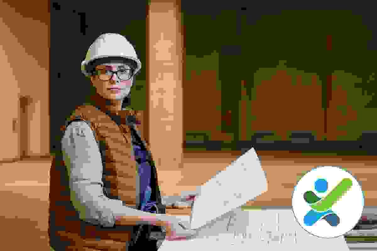 A female access consultant wearing a hardhat is staring at the camera while holding an architectural drawing A female access consultant wearing a hardhat is staring at the camera while holding an architectural drawing
