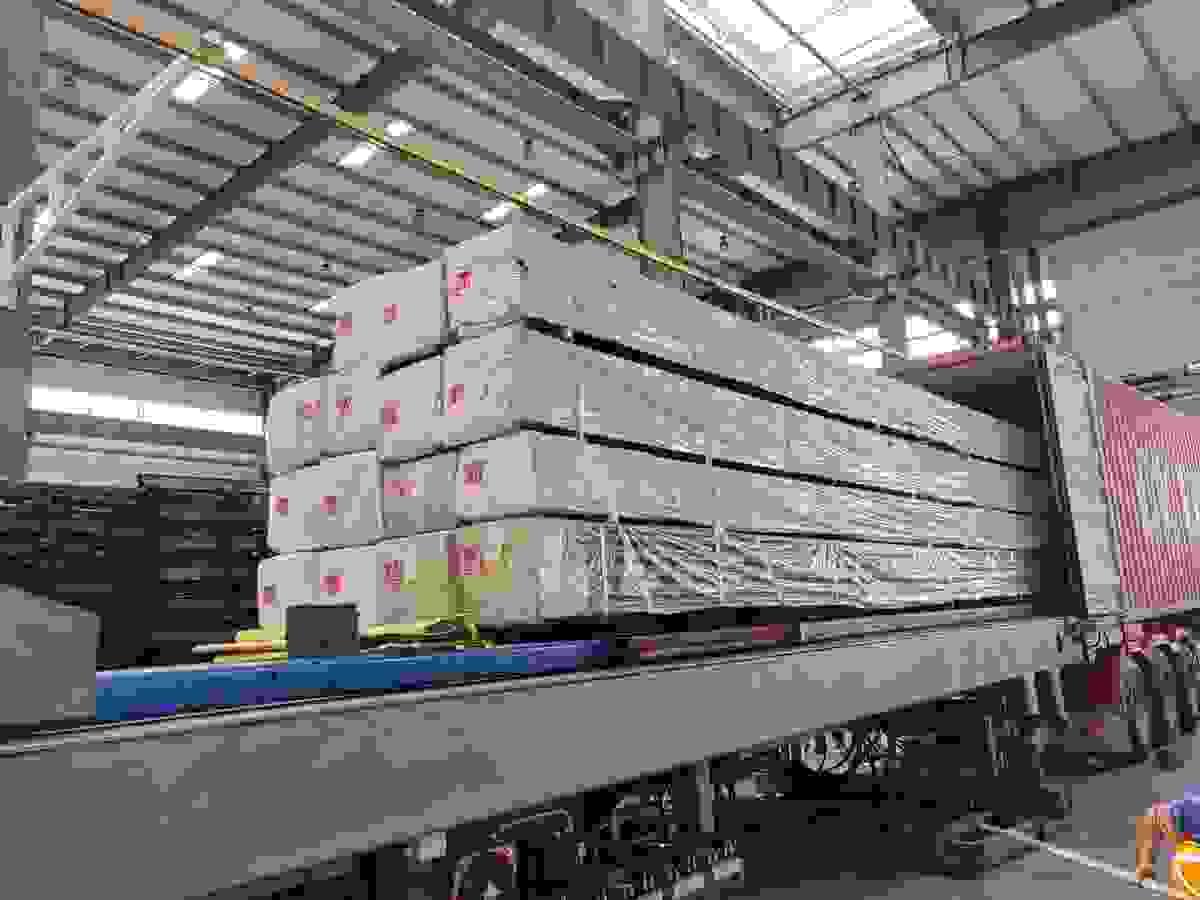 Loading uprights into container Loading uprights into container