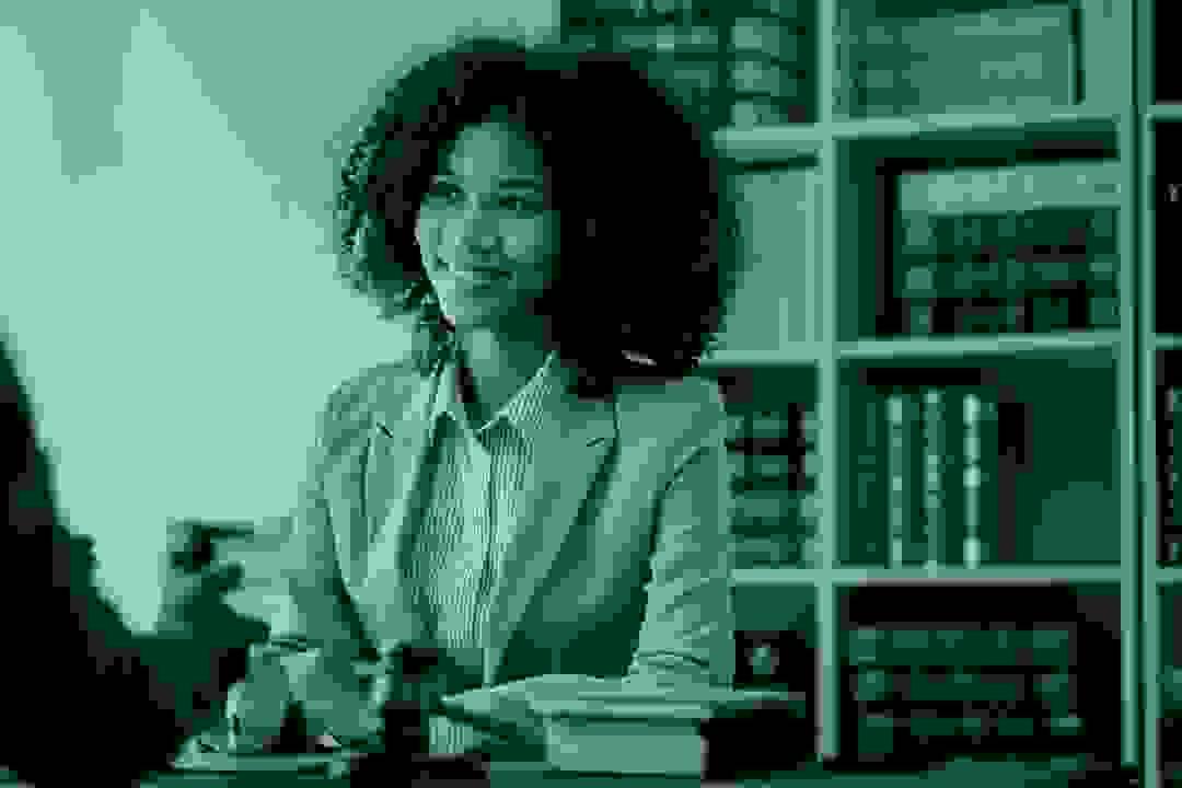 Solo attorney working at a desk with law books and laptop Solo attorney working at a desk with law books and laptop