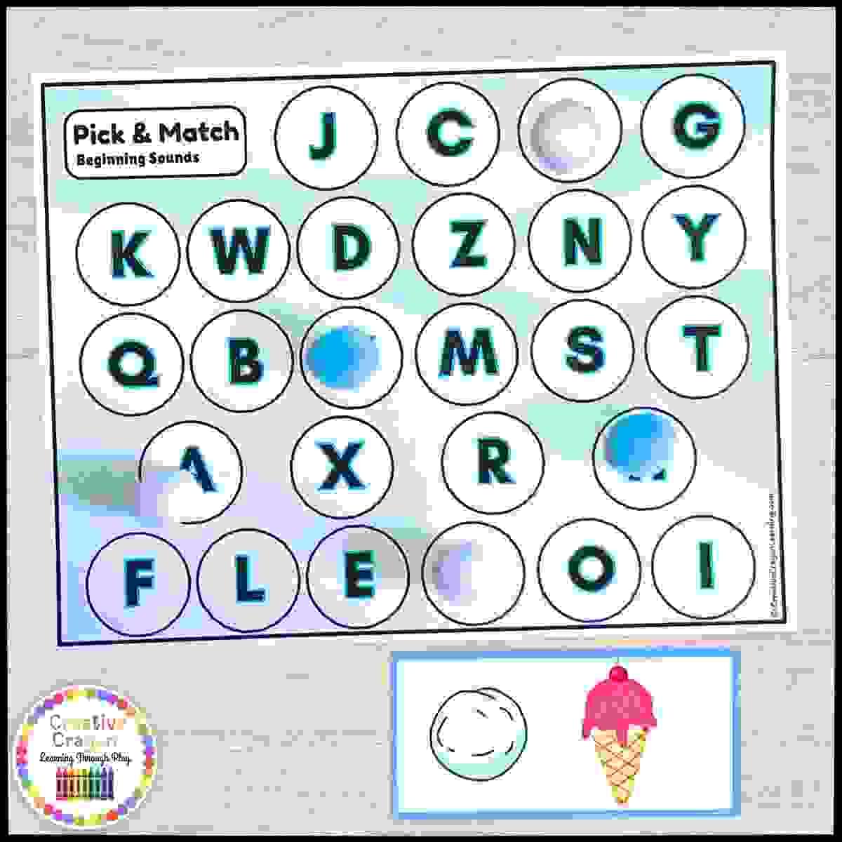 Kindergarten alphabet sound matching activity with plastic snowballs and picture mats for hands-on phonics practice