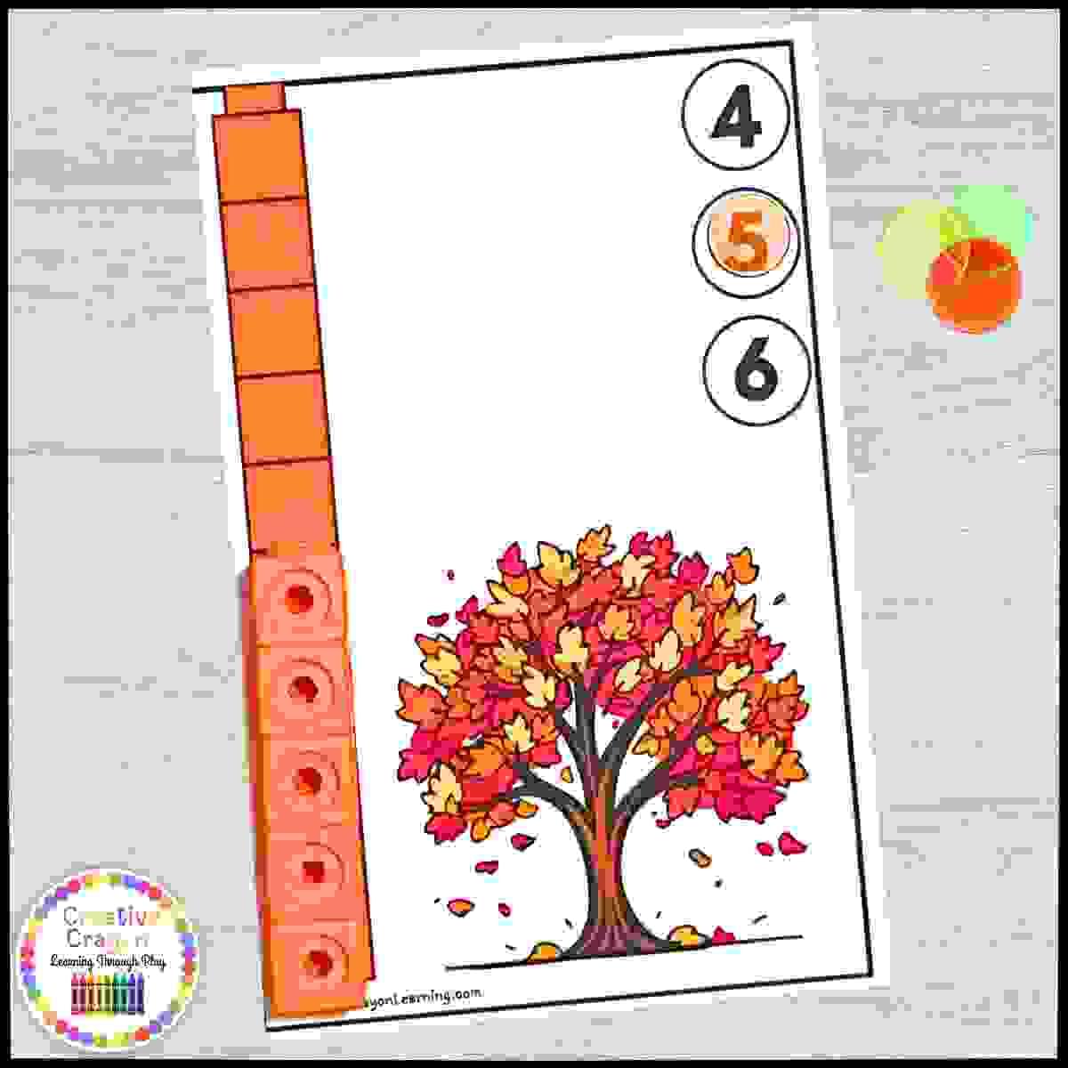 Fall-themed measurement center for kindergarten with math link cubes and seasonal character cards.