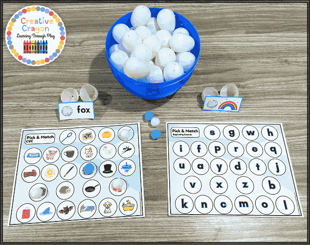 Snowball Pick & Match literacy center setup with a basket of plastic snowballs and picture mats laid out for hands-on winter phonics practice in kindergarten and first grade