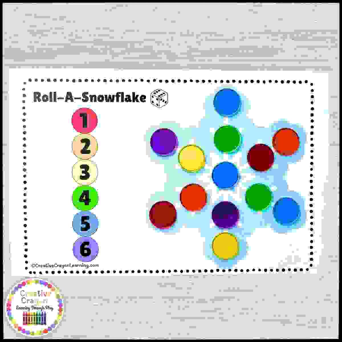 Kindergarten snowflake roll-and-cover winter math game using dice and bingo chips