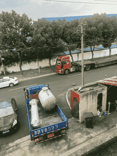 Dedicated trucks staged outside the plant for shipment to Shandong.
