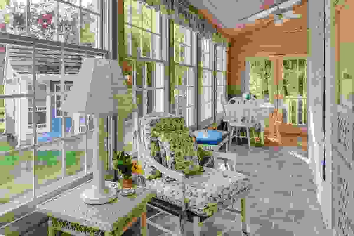A place for morning coffee and evening relaxing beautiful matching floor and trim color with white railing and black handrail wrap around porch in Roanoke 